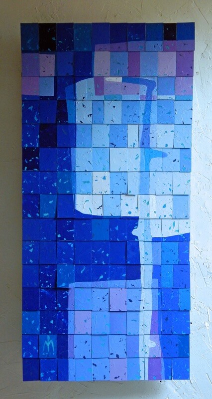 An abstract image of a hand carved walking staff painted on tiles in various shades of blue to purple
