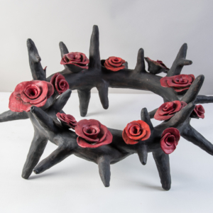 The Amulet Series 1 is a low fired clay smaller crown of thorns with various sized red roses.