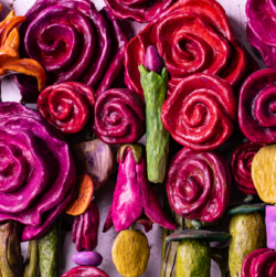 Close-up of vibrant, abstract roses and other flowers in red, pink, and orange hues from the mixed media artwork "Bouquet For Grace" by Oklahoma artist Paul Medina.