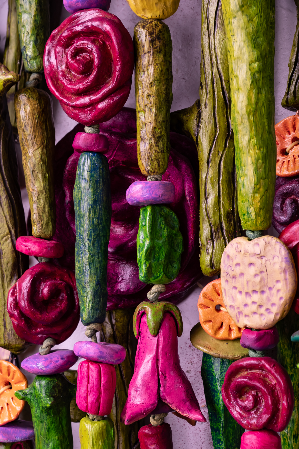 Close-up of vibrant, abstract roses and other flowers in red, pink, and orange hues from the mixed media artwork "Bouquet For Grace" by Oklahoma artist Paul Medina.