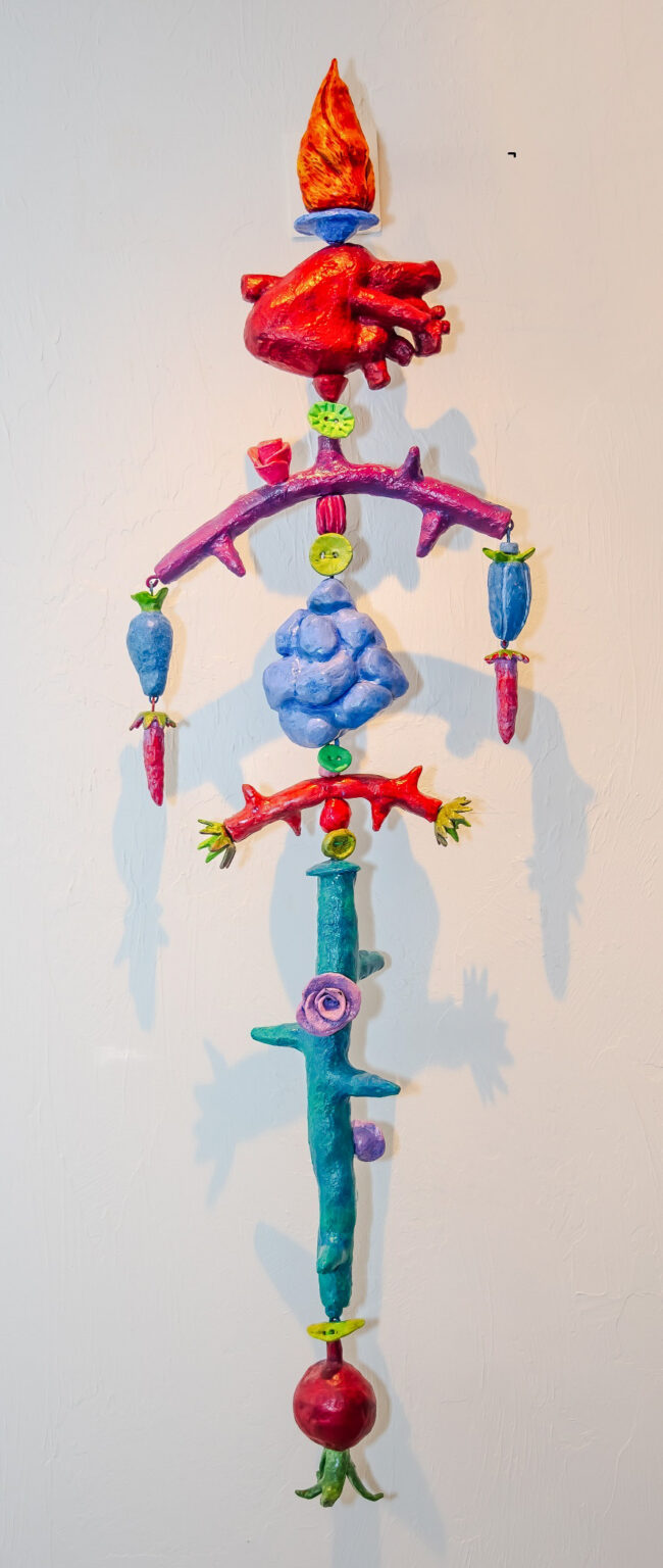 I Give You My Heart is a 12" x 54" x 8"mixed media on fired clay, steel, copper and nylon cord.