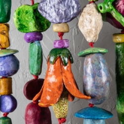 THINKING OF YOU (2025) is a 5&#039;x5&#039;x9&quot; wall amulet made of mixed media on low-fired clay, steel, copper and nylon cord.