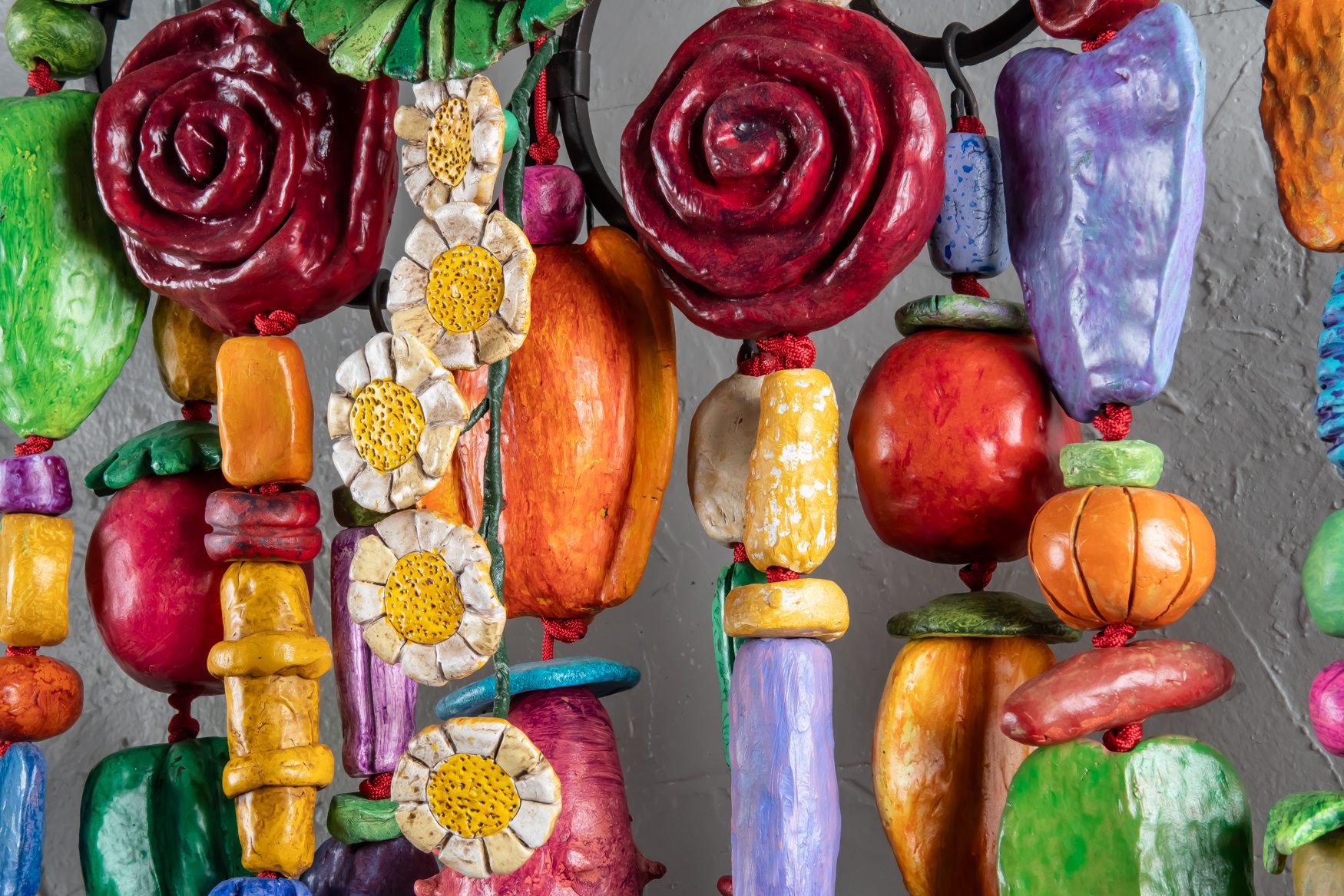 THINKING OF YOU (2025) is a 5'x5'x9" wall amulet made of mixed media on low-fired clay, steel, copper and nylon cord.