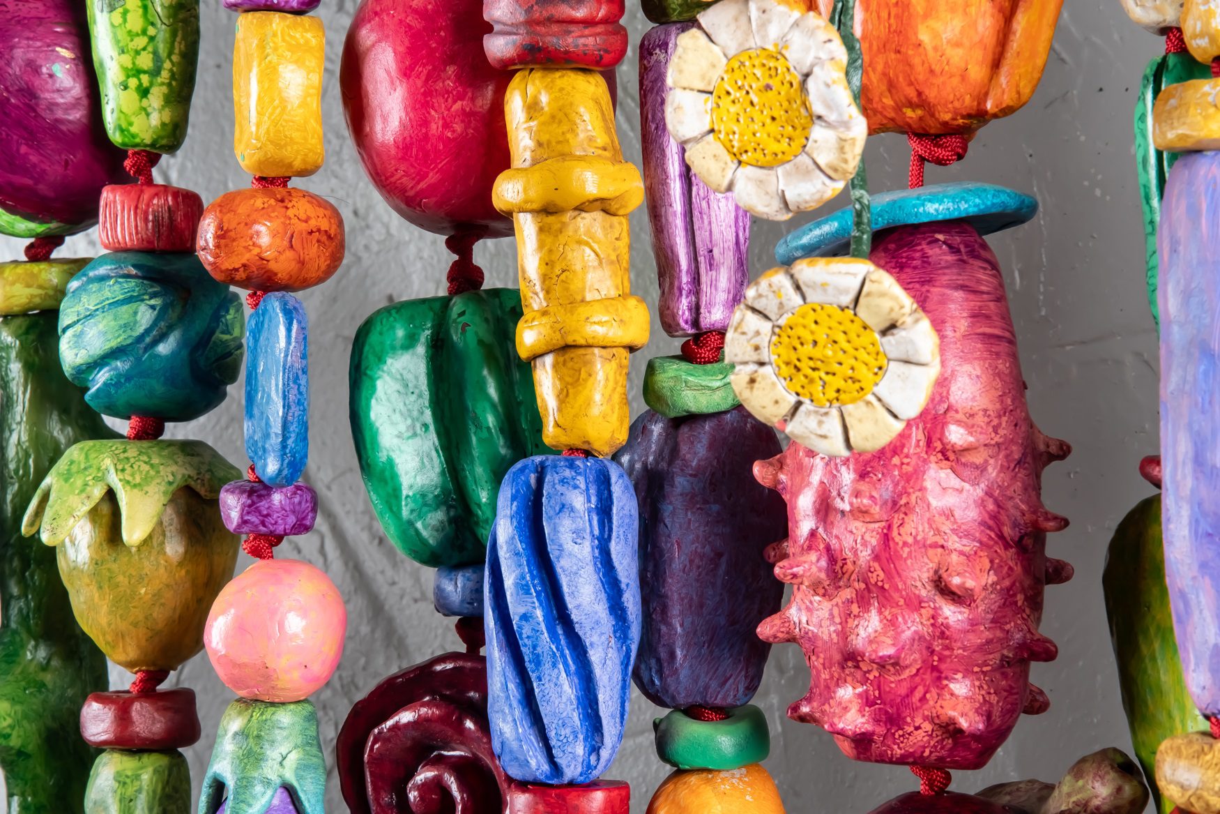 THINKING OF YOU (2025) is a 5'x5'x9" wall amulet made of mixed media on low-fired clay, steel, copper and nylon cord.